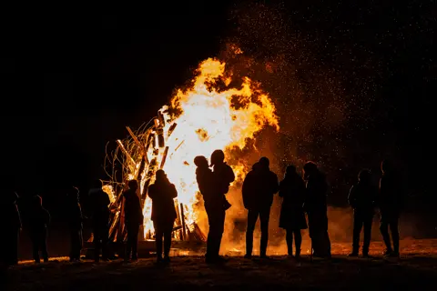 People gathered before the blaze