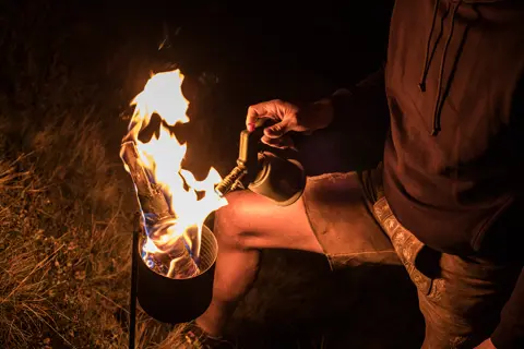 A man tending the fire