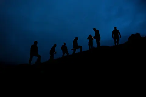 People gathered in the luminous glow