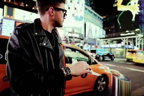 Man with a leica camera and a leica watch on the street