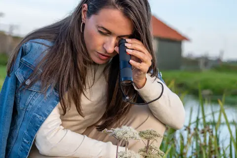 Woman is looking through her Leica Monovid