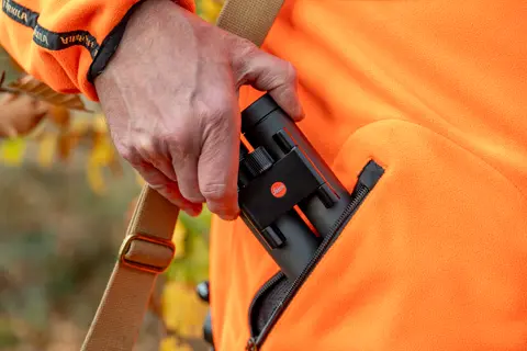 Hunter is pulling his Leica Noctivid Compact out of his pocket