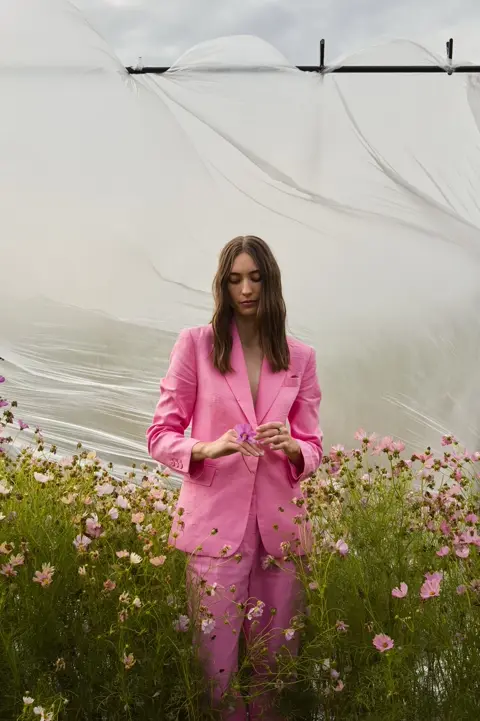 female model in pink suit