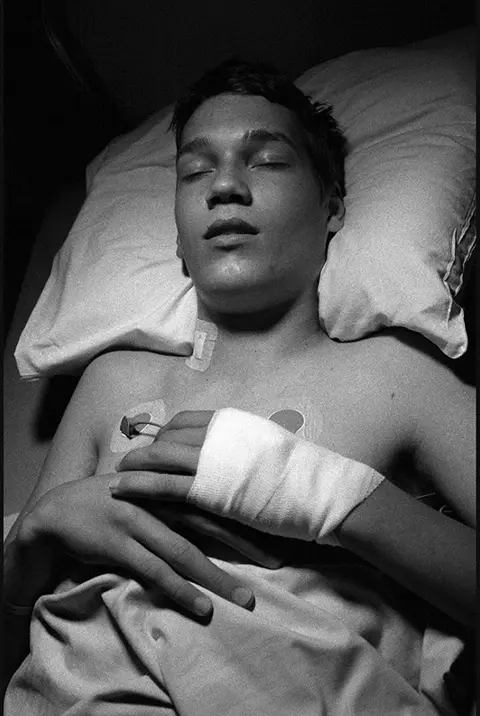 man laying in bed b&w