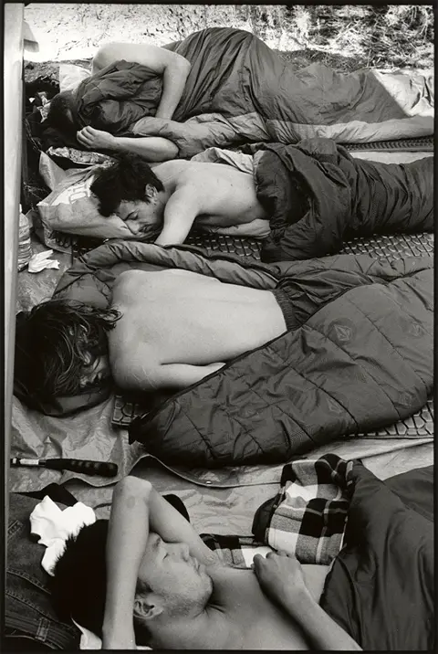 people sleeping on floor b&w