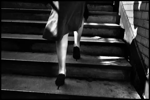 woman going up the stairs b&w