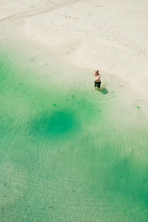 Colour image of a British seaside with a man by the sea