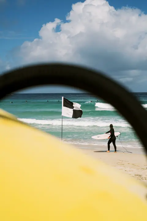 Colour image of a surfer in the beach.