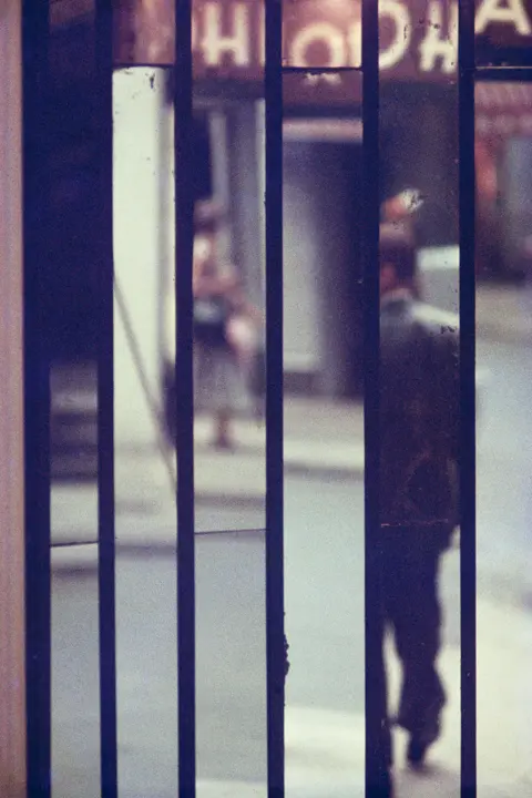 Saul Leiter Man in a Mirrow with several rexlexions
