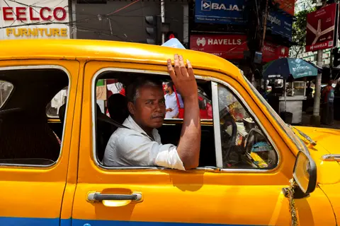 Man in his yellow taxi