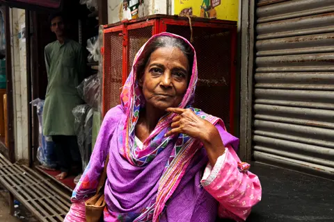 Old woman wearing a linen gown