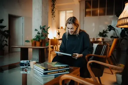 laura sitting on a chair with her book