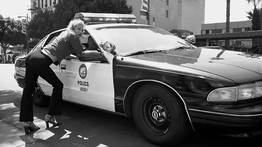 Woman standing by a police car in America