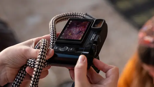 Julia looks at the screen of her Leica Q camera
