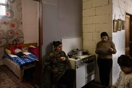 Family gathered inside a modest home, capturing domestic life, togetherness, and multigenerational living.