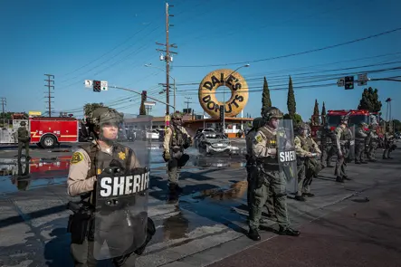 Sheriff deputies secure an intersection during a public incident, capturing law enforcement presence in an urban environment.