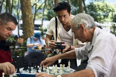 Photographer Billy Dinh documents an outdoor chess match with a Leica Q in a New York City park, capturing authentic street photography and everyday urban life.
