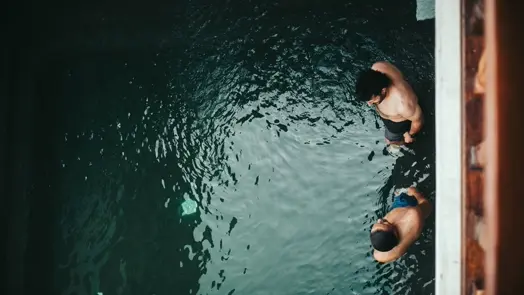 Two people are about to jump into the water