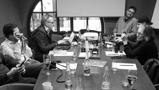 Participants explore Leica cameras during a hands-on photography workshop.