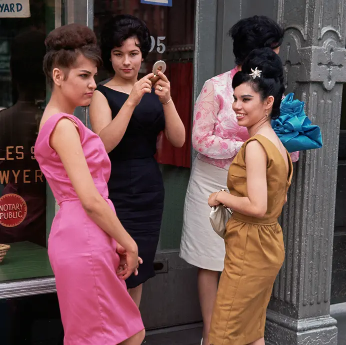 Four woman standing in front of a shop.