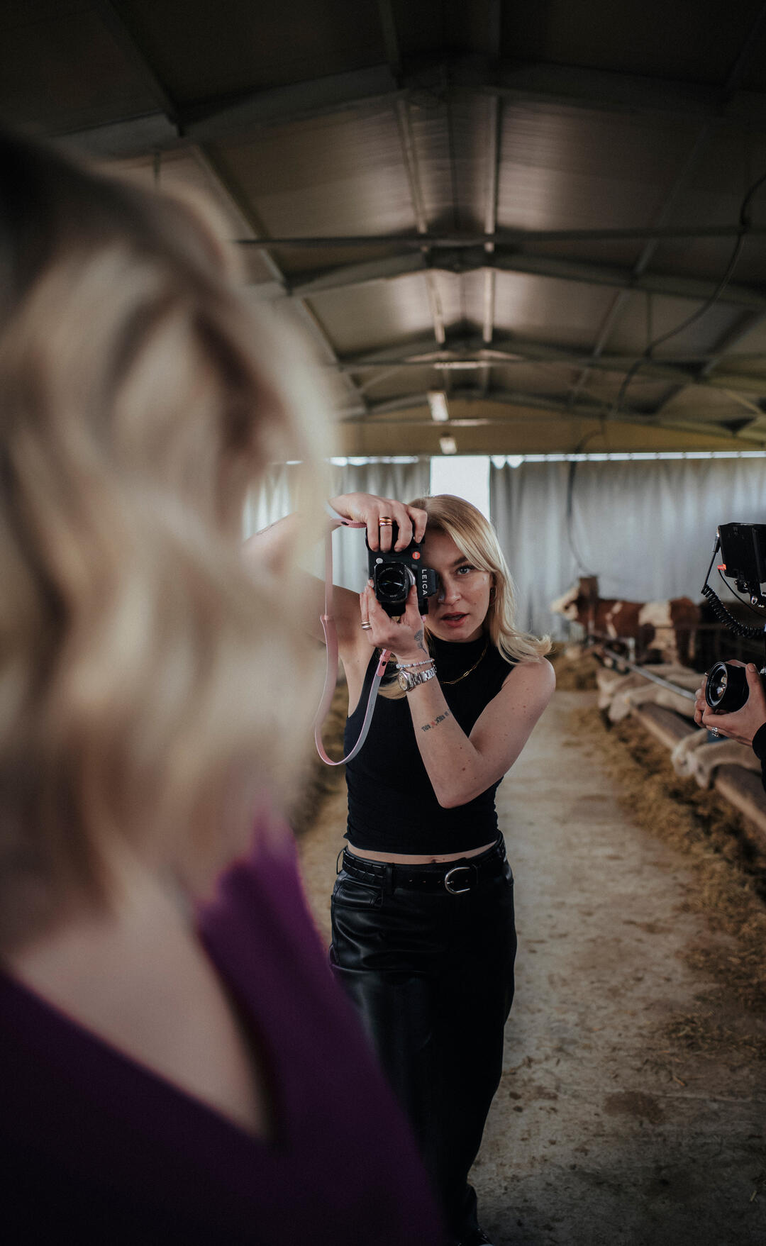 Woman photographs a model in the sheepfold