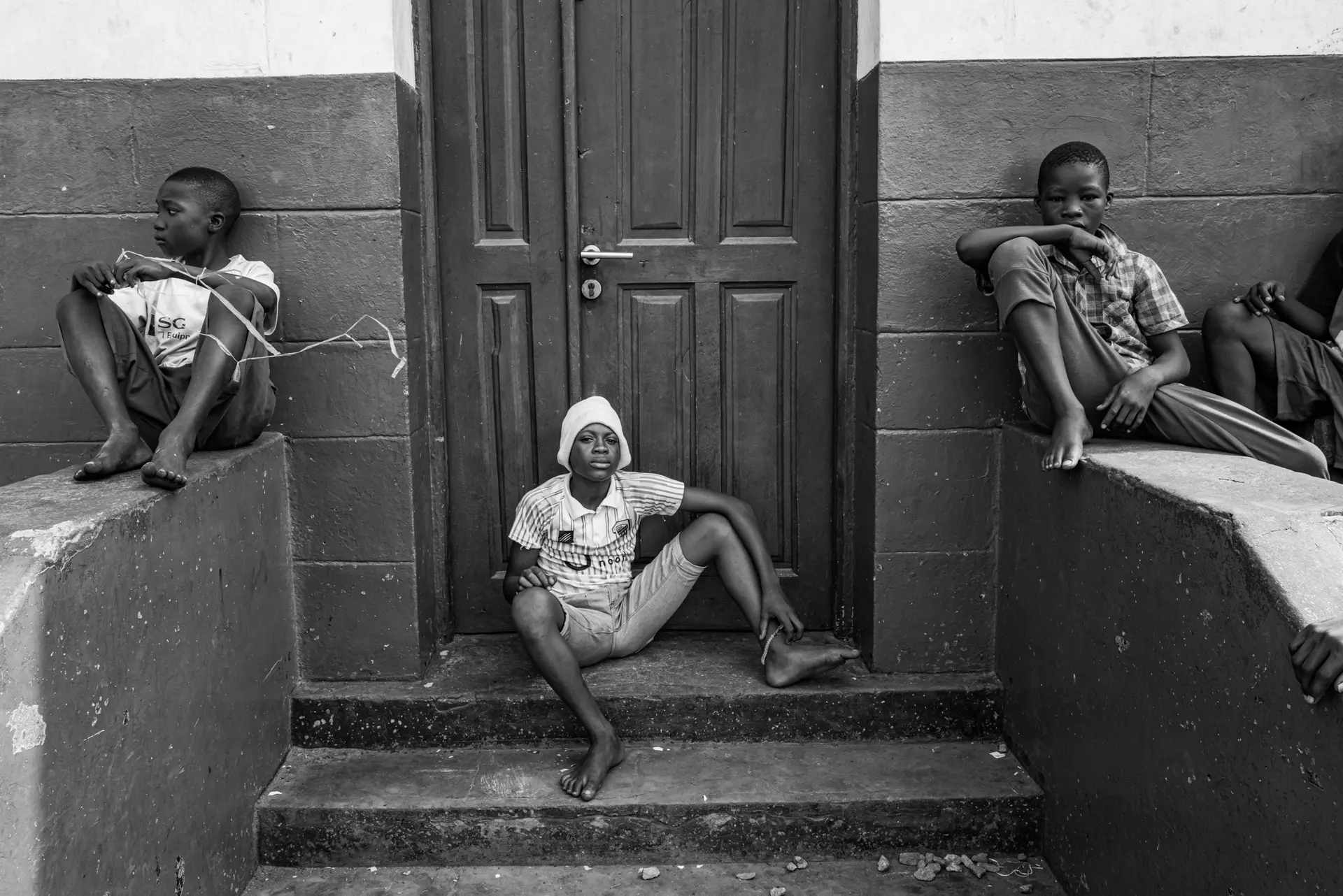 three children on a stoop