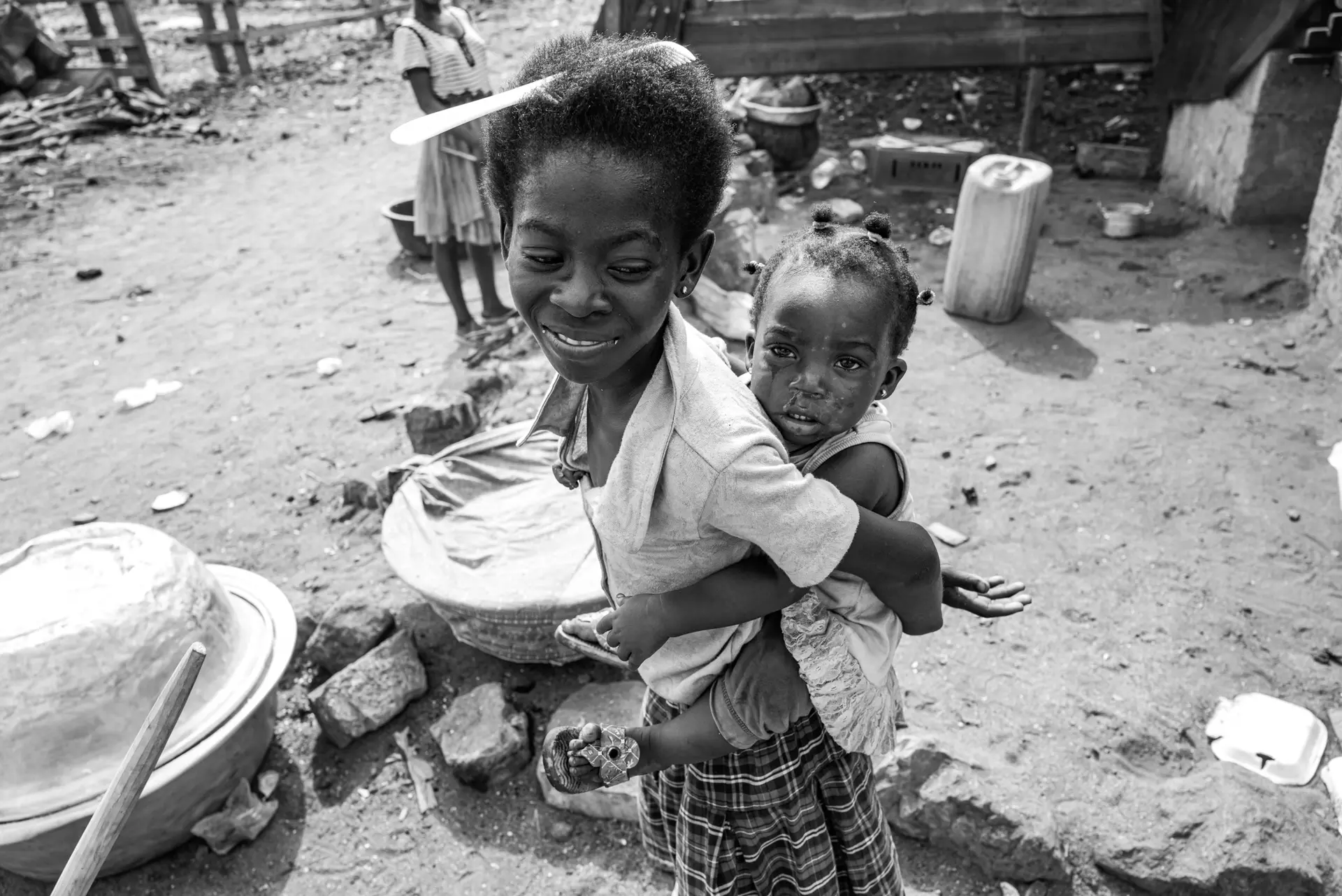 Girl holding younger girl on back