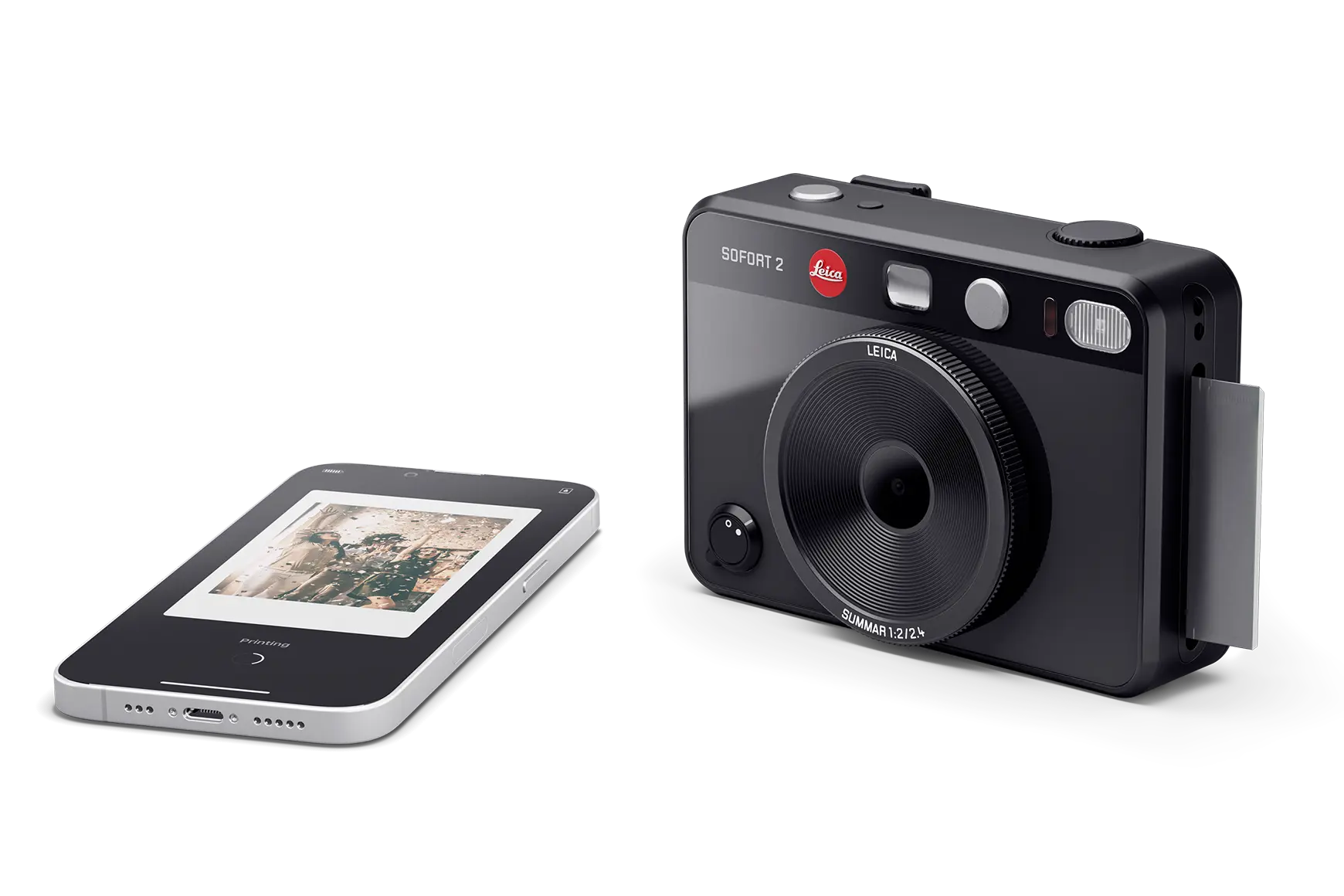 Leica Sofort 2 black beside mobile phone.