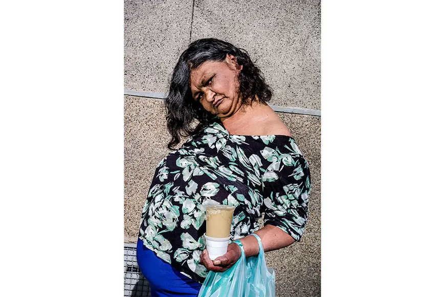 Woman with a drink in her hand and a shopping bag