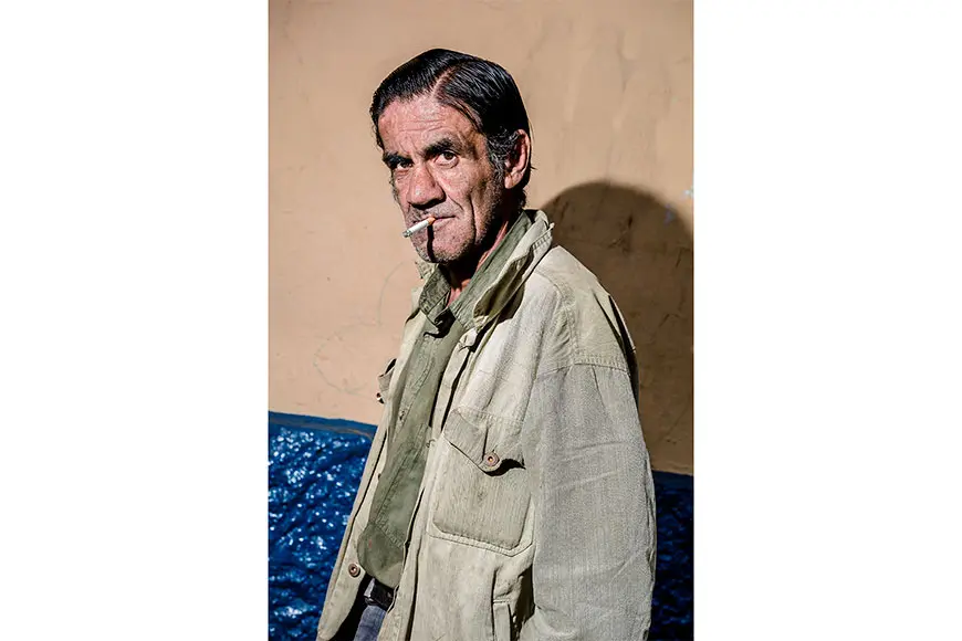 Man with cigarette and brown jacket