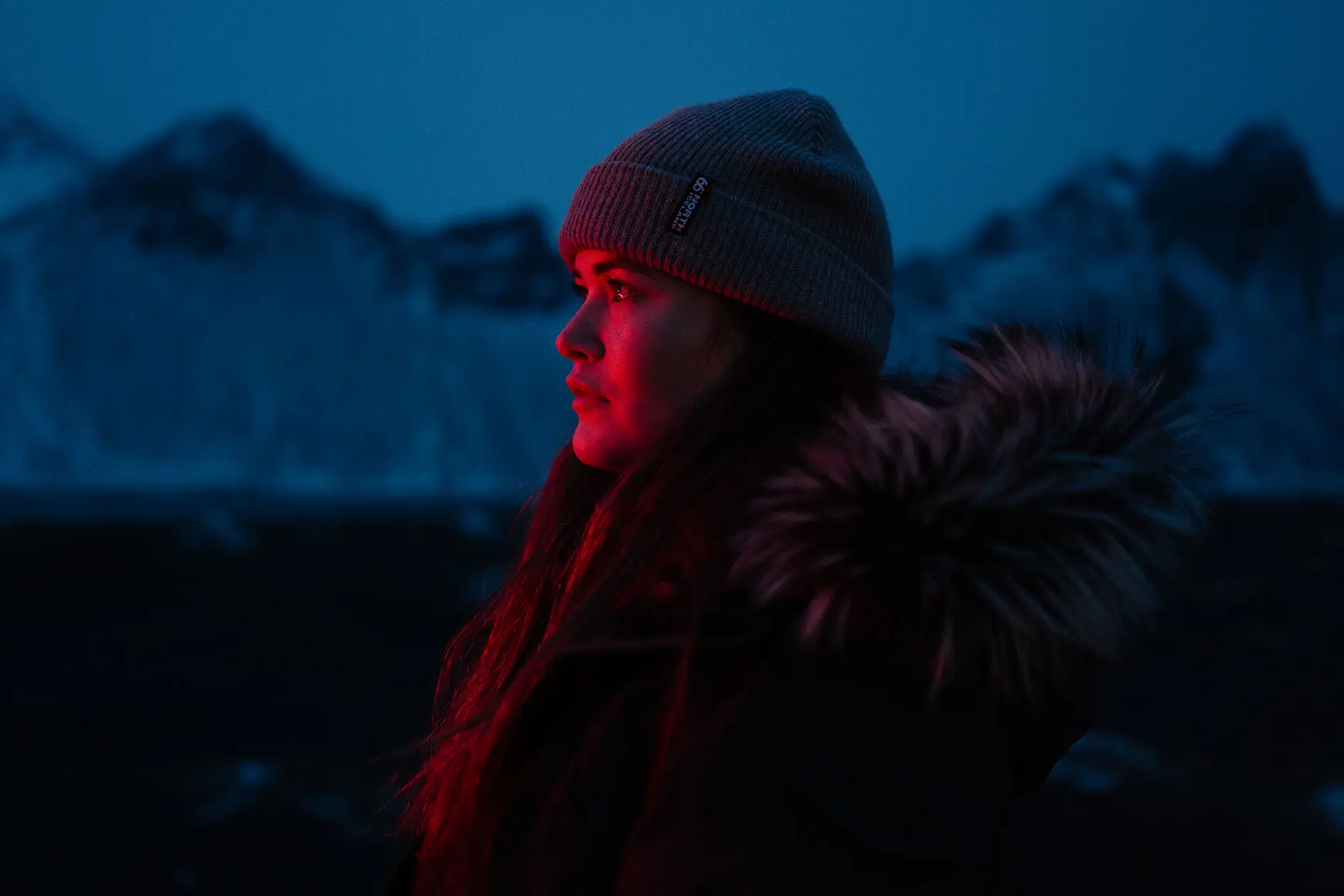 Woman stands in front of mountains