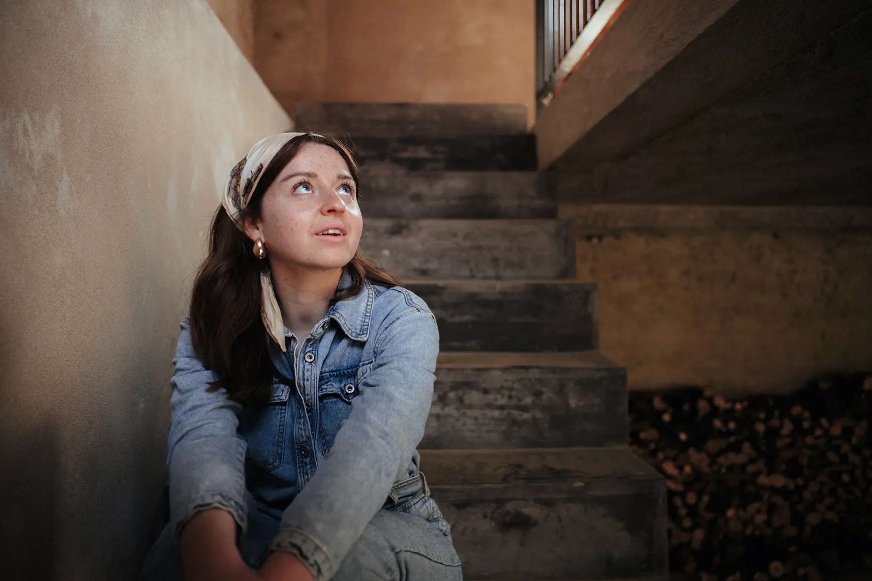 Model sits on a staircase