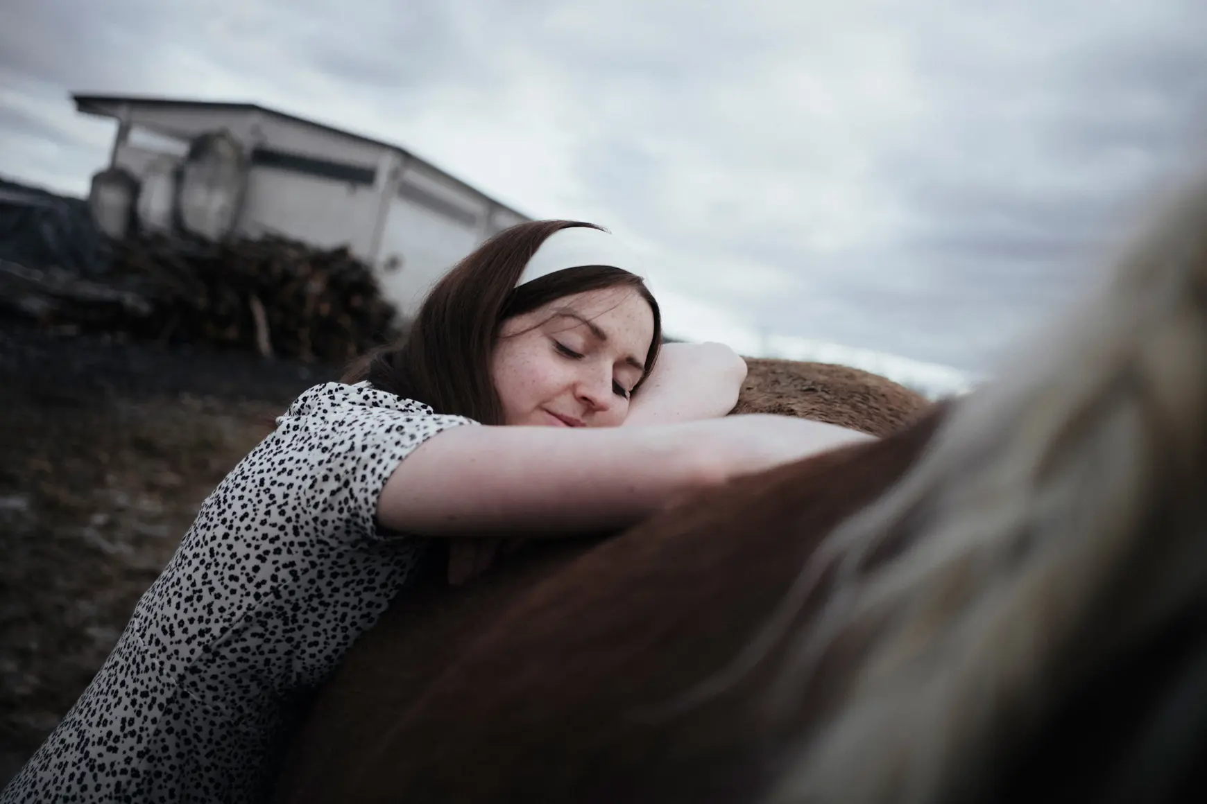 Woman leaning against a horse