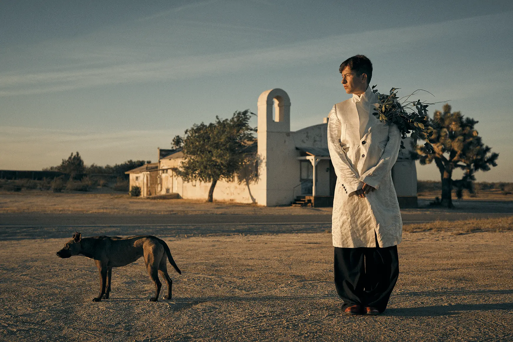 A portrait of Barry Keoghan with a dog. 