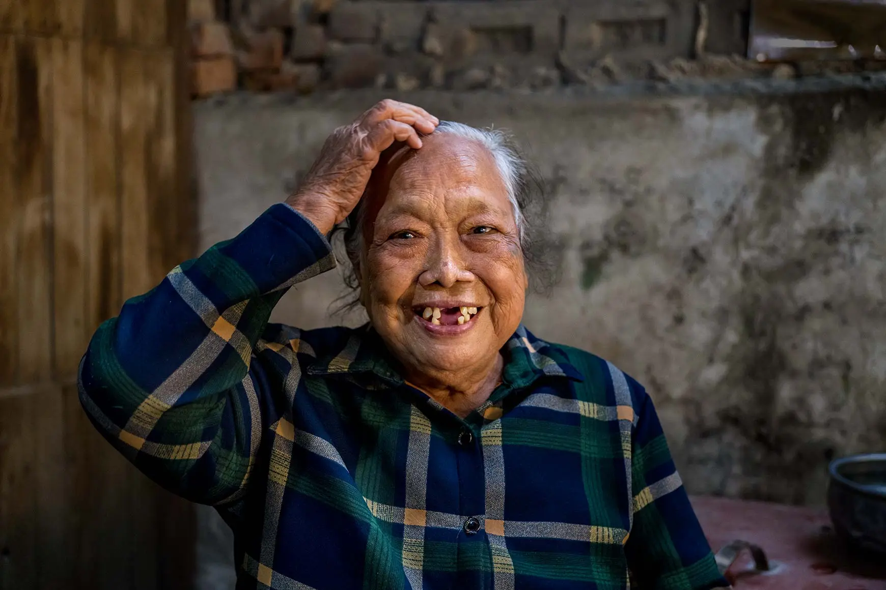 laughing woman with hand on her head