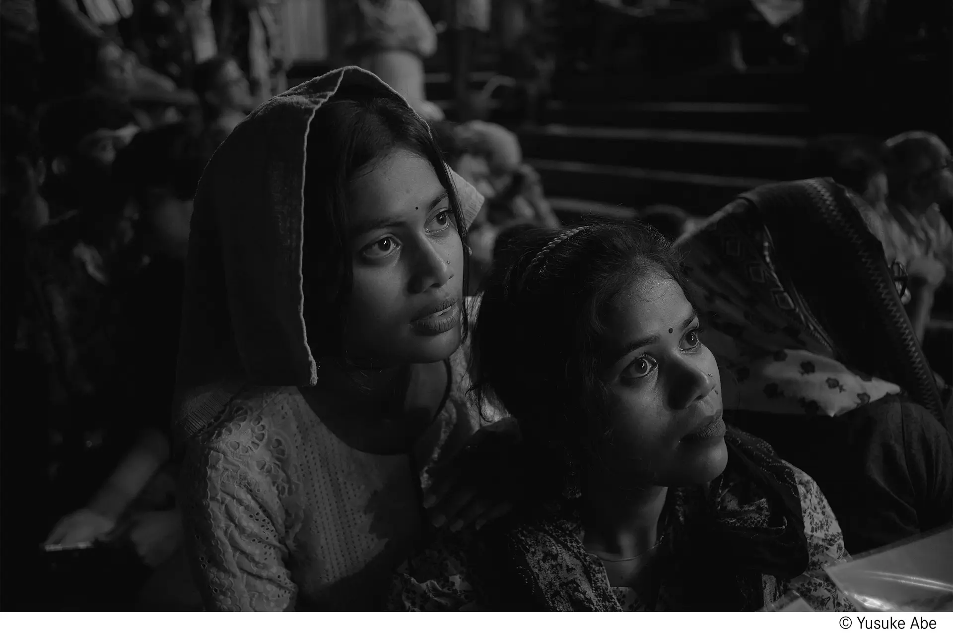 Two girls staring at something in India.