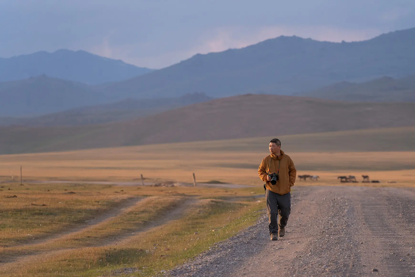 Man in the landscape in front of mountains