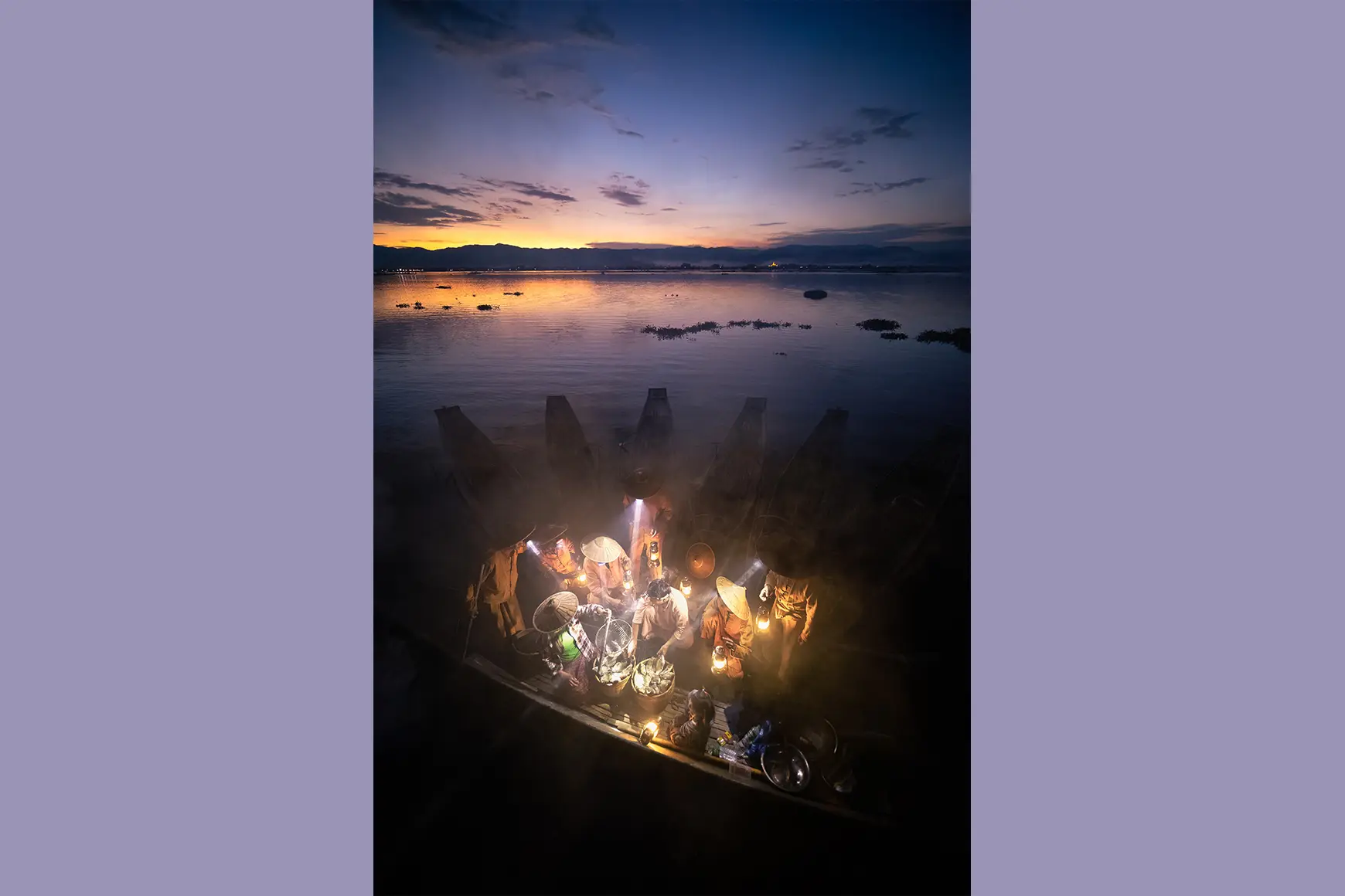 Fishermen on their boats at night