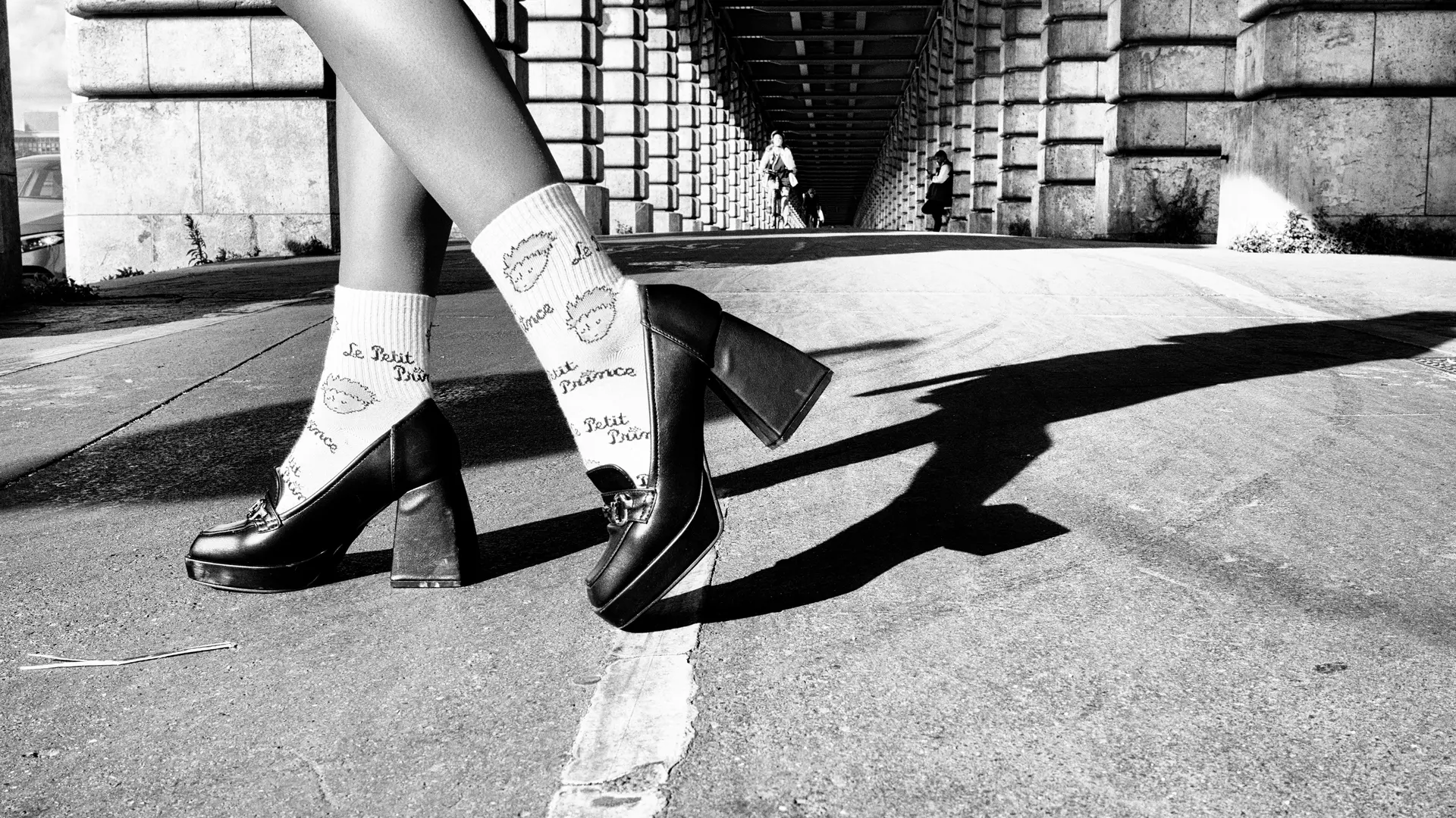 Picture detail from foot to knee of woman with high heels in the streets