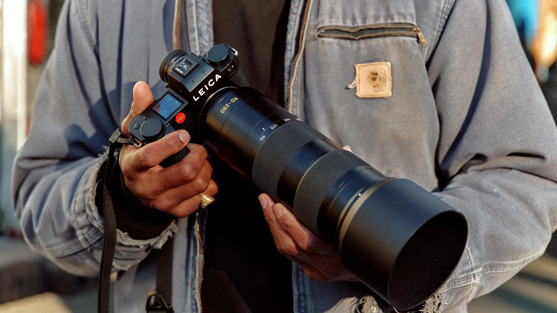 A man holding a Leica camera in his hand