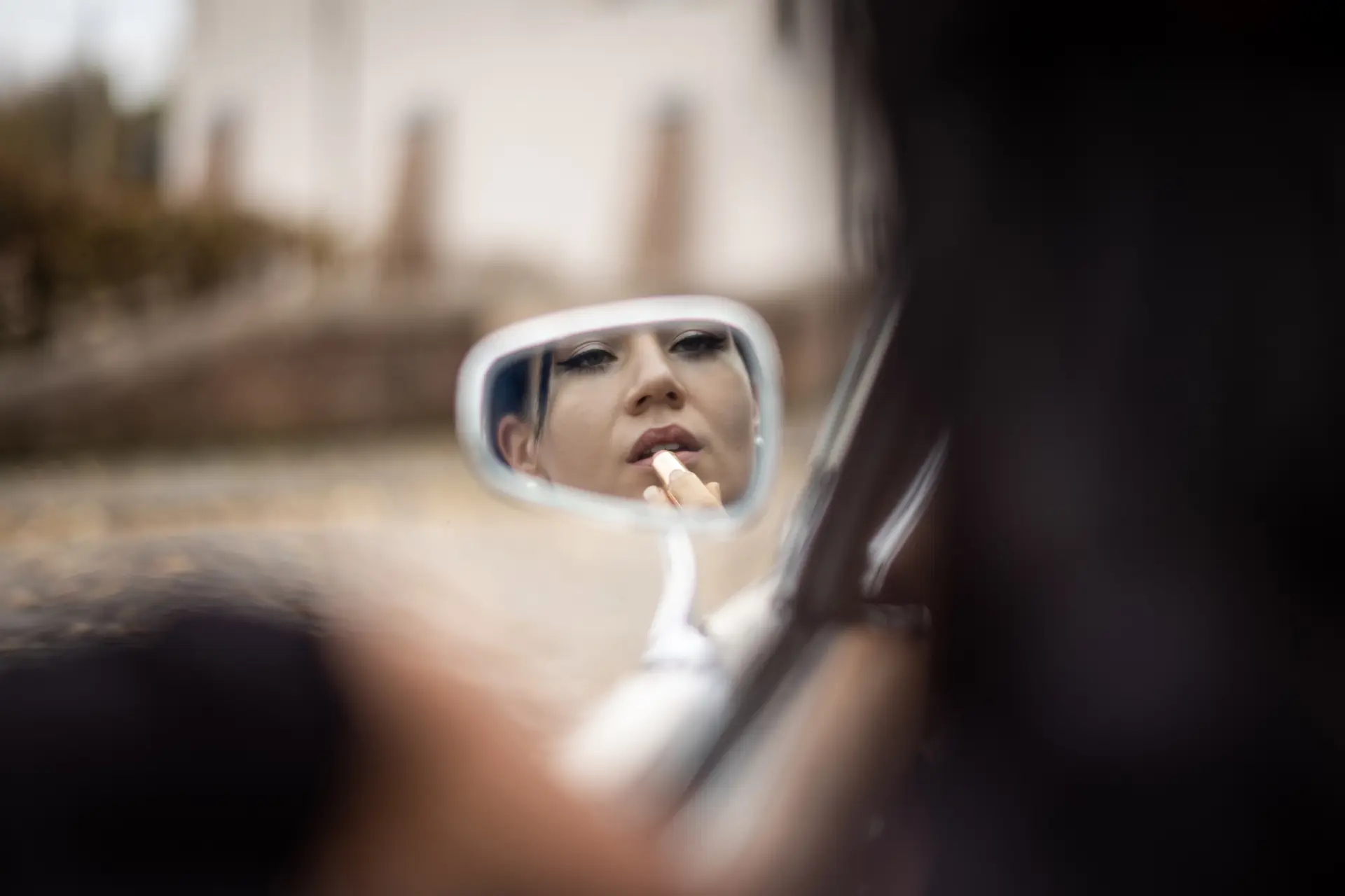 Woman in a car looking in the mirror