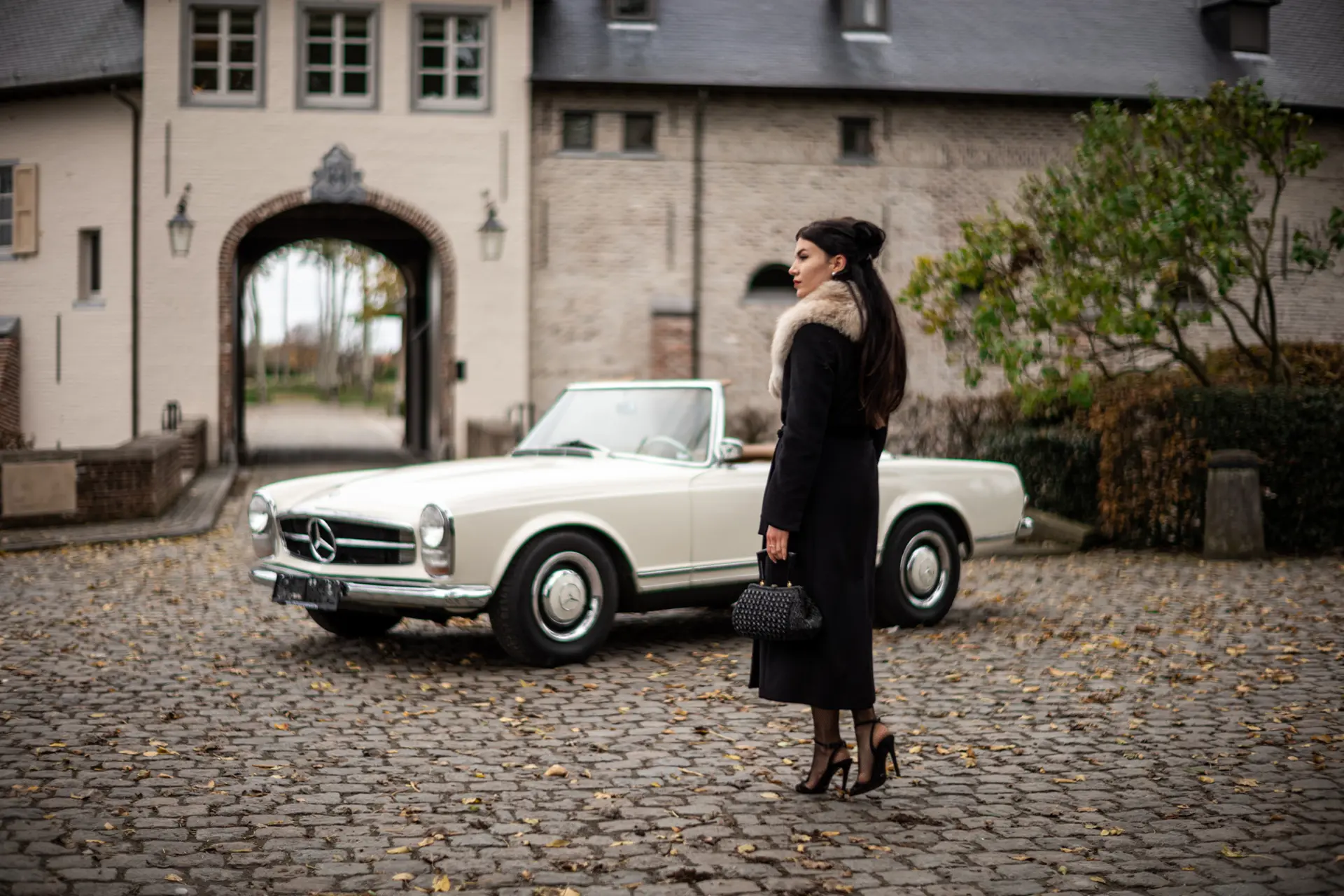 Woman in front of an oldtimer 