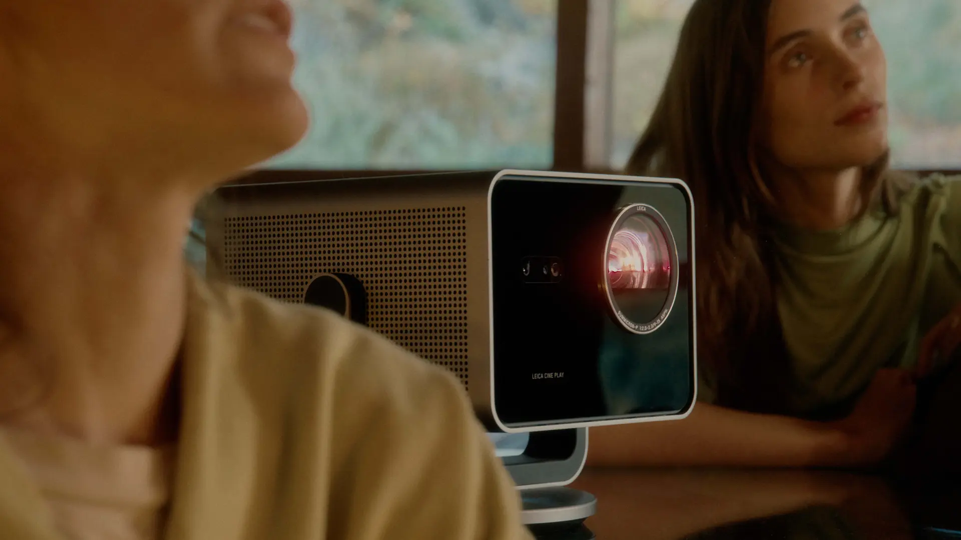 Two women sitting beside the Leica Cine Play 1.