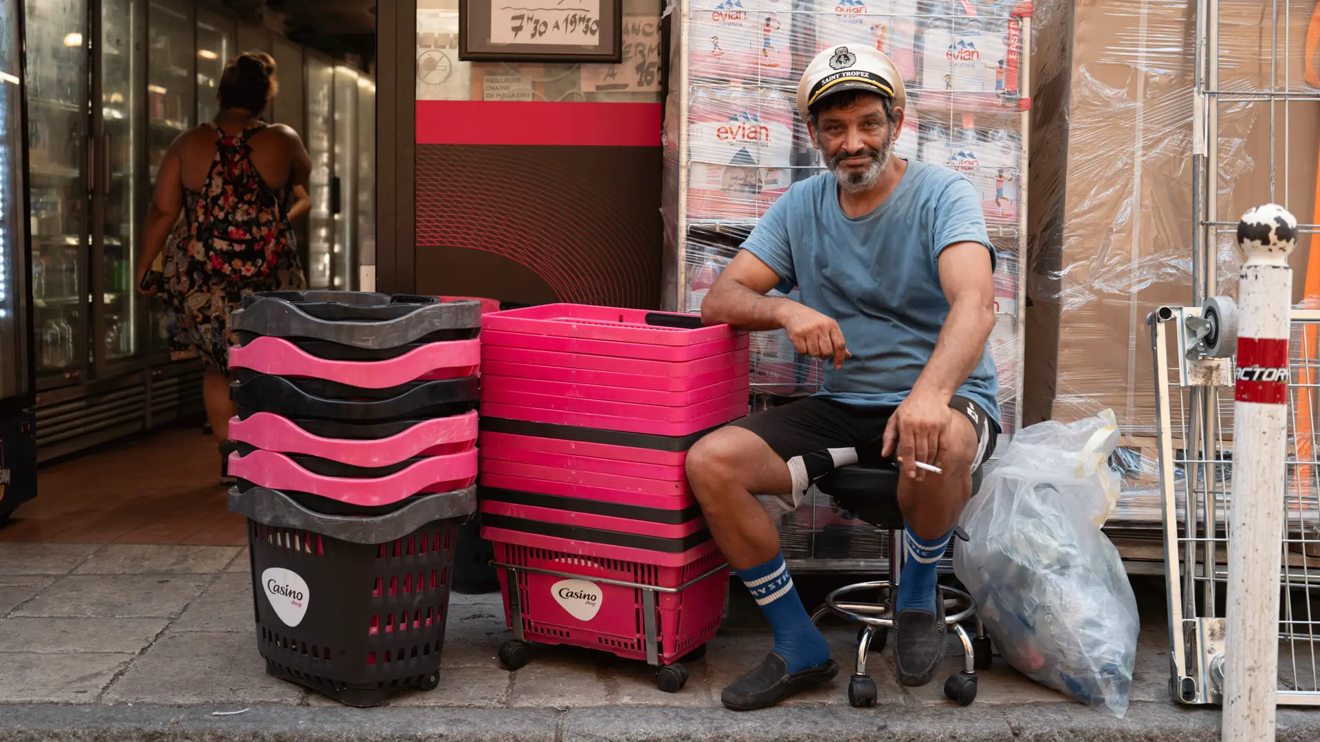 Image of a vendor sitting by a shop.