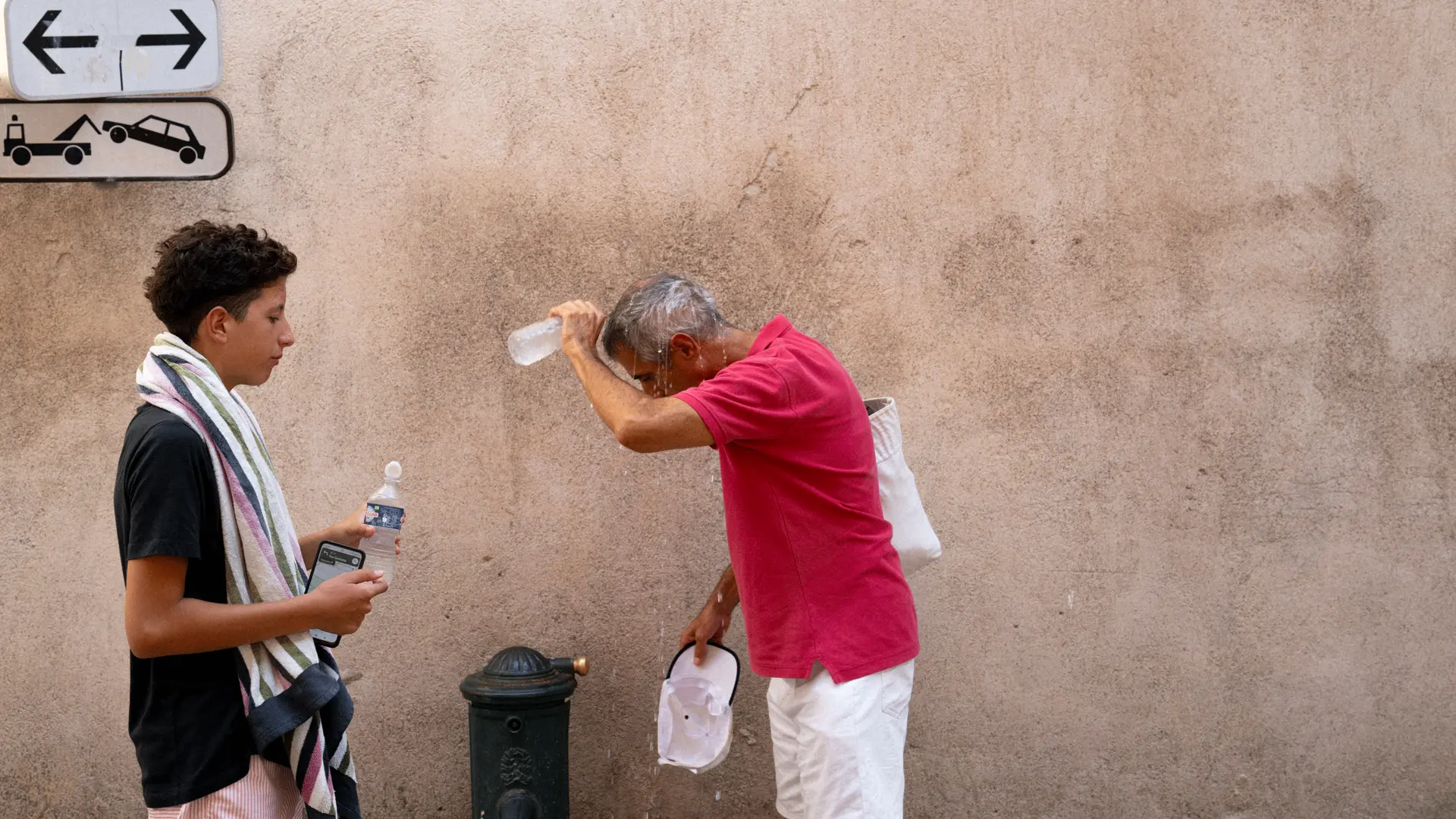 Image of two men by a water fountain.