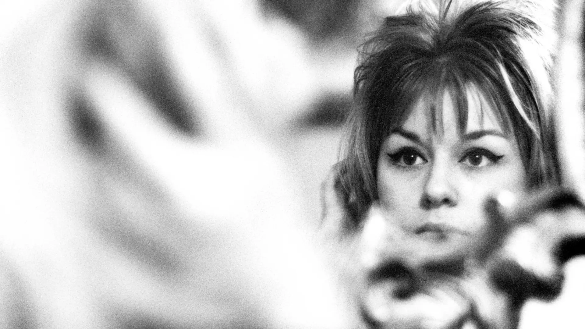 Woman in front of a mirror in black and white.