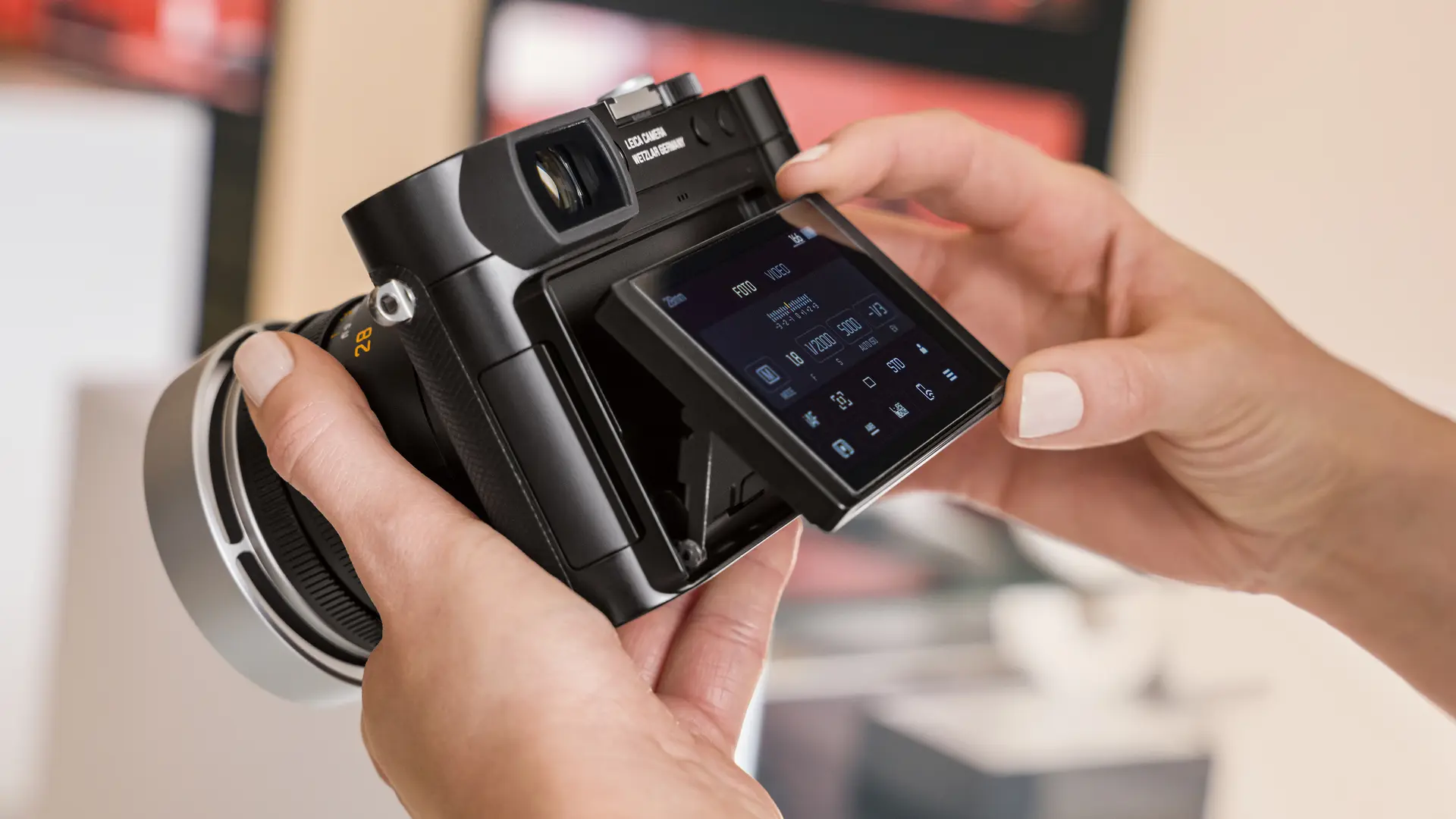 Hands holding a Leica camera