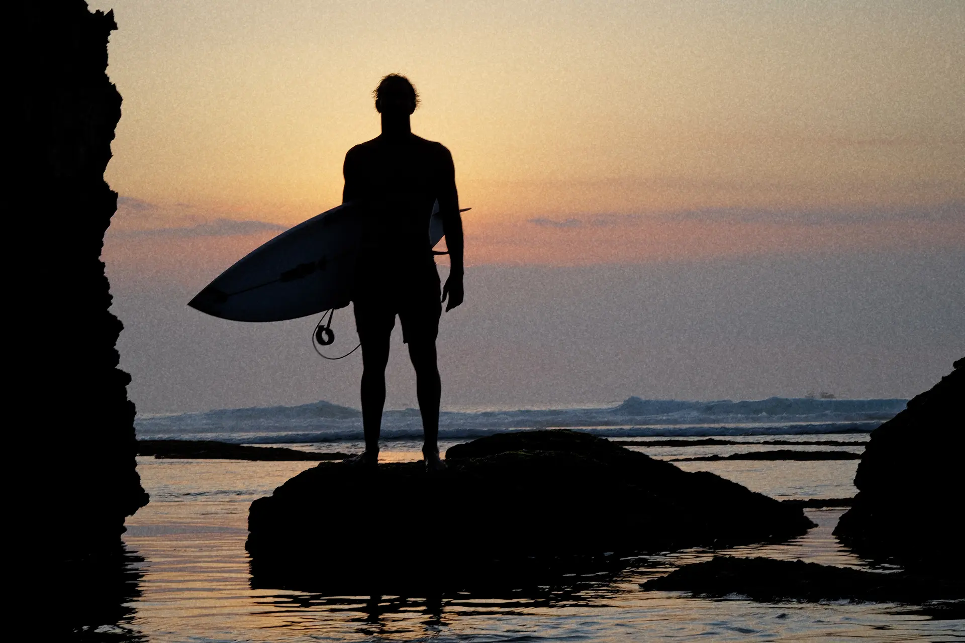Surfer enjoying sunset at the beach