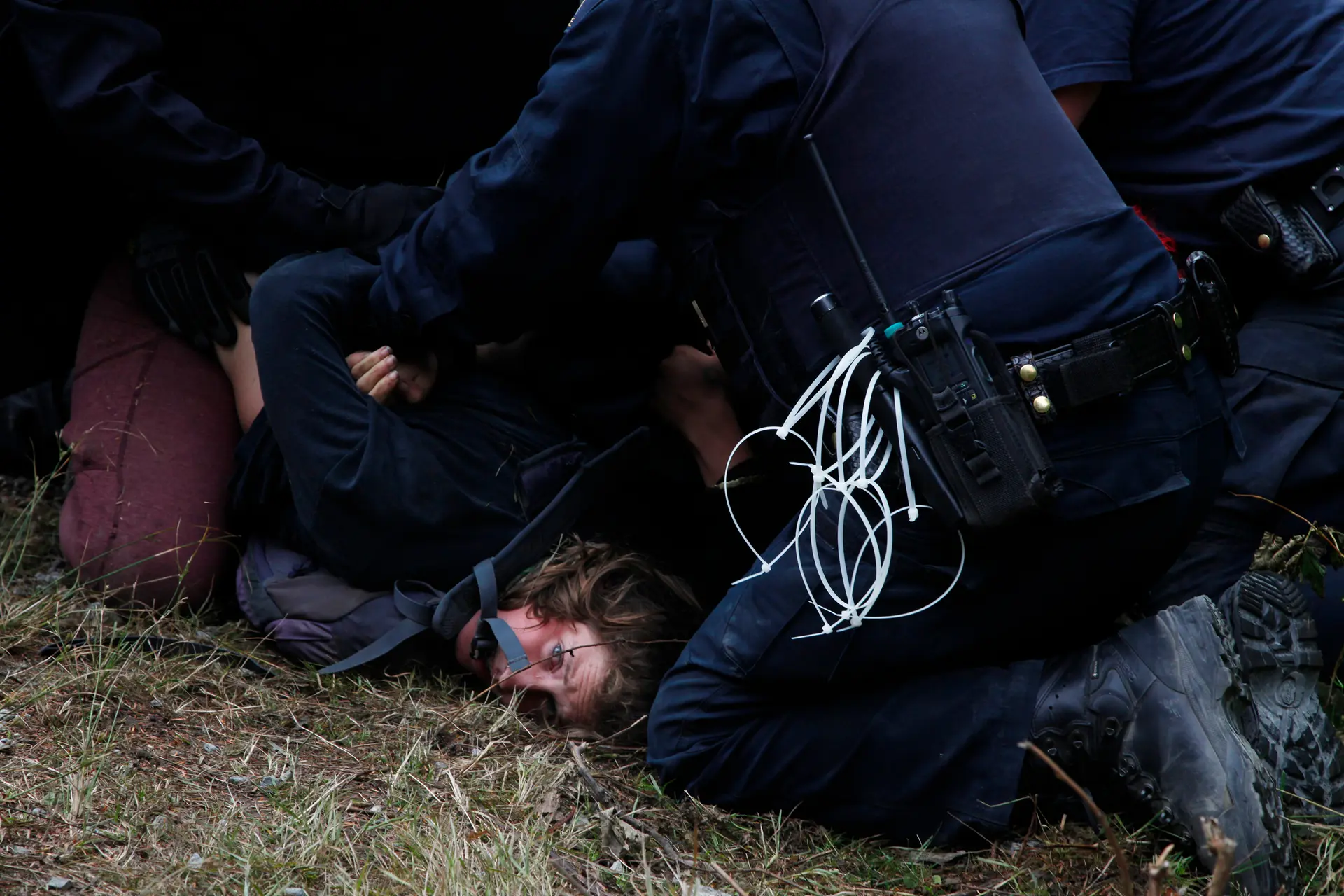 woman activists is arrested in the forest by a police officer
