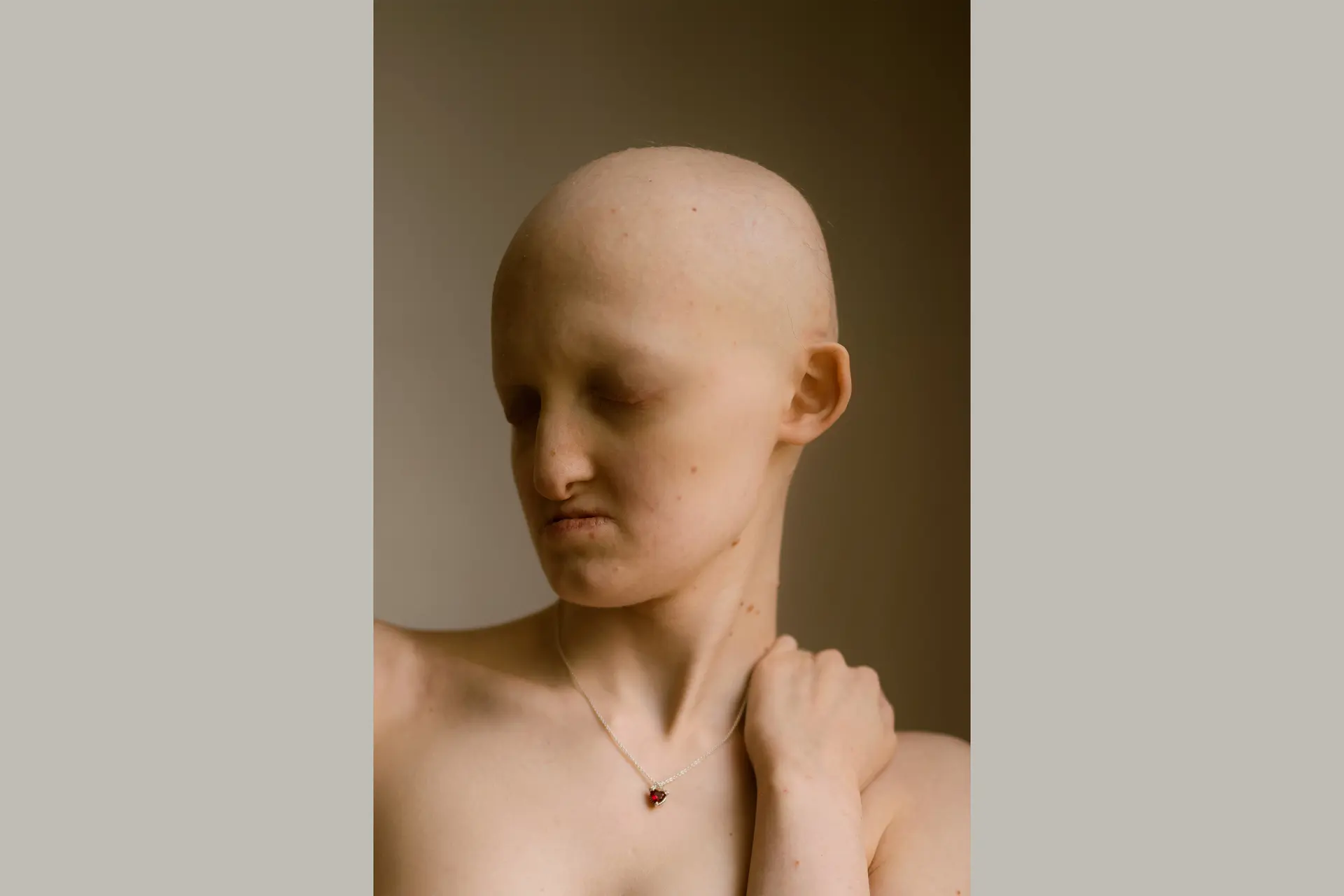 Woman with bald head and closed eyes